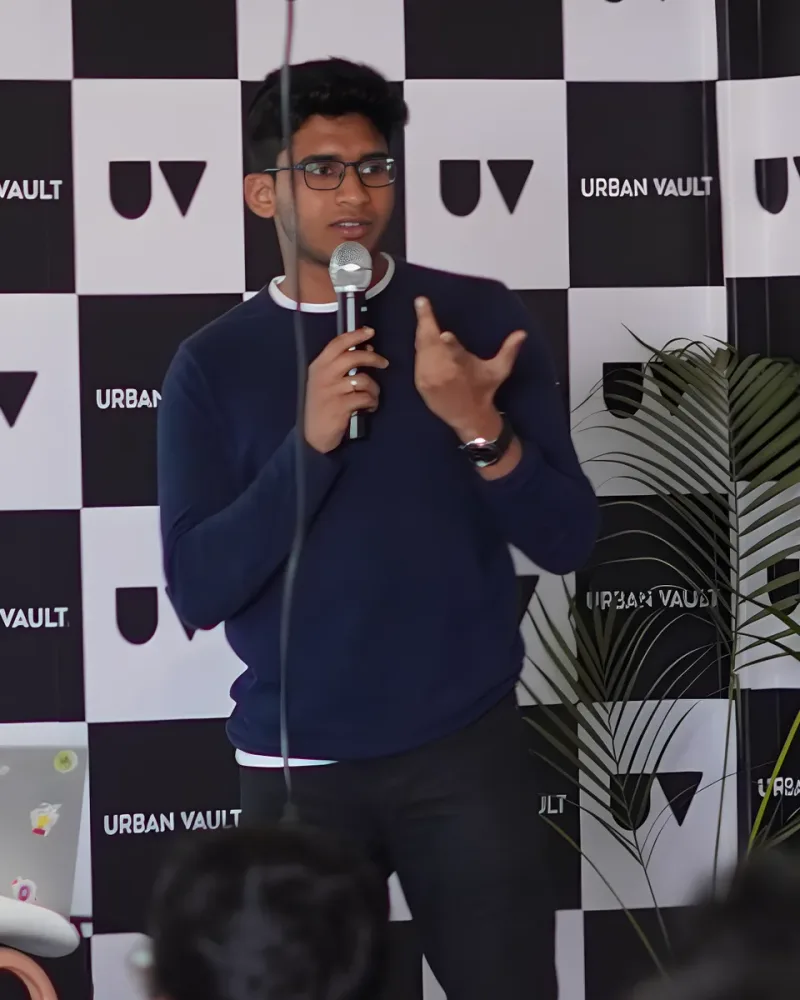 Mishal Abdullah giving a talk, holding a microphone